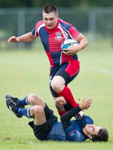 MAKING TRACKS &#8211; St. Albert junior Connor Blackburn runs over a fallen Clan player in Wednesday&#8217;s U19 contest at Ellerslie Rugby Park. The Clan Blue team scored a