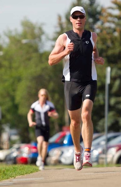 GOING THE DISTANCE &#8211; Allan Maloney of St. Albert motors towards the finish line at the 24th annual St. Albert Triathlon on Sunday. Maloney was the 57th overall finisher 