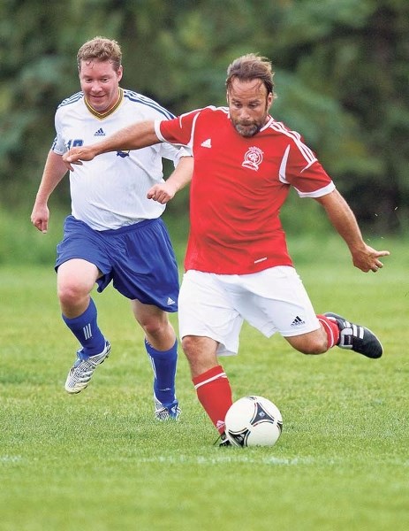 KICK TO WIN &#8211; Mike Thompson of the St. Albert Impact Rangers winds up for a big boot in front of St. Albert Impact player Fred Bisson in the Edmonton District Soccer