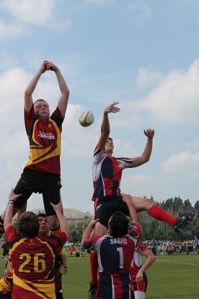 FLYING OBJECT &#8211; A lineout ball sails past St. Albert jumper Ben Kluyts (right) and his Nor&#8217;Westers&#8217; counterpart in the Edmonton Rugby Union&#8217;s U17
