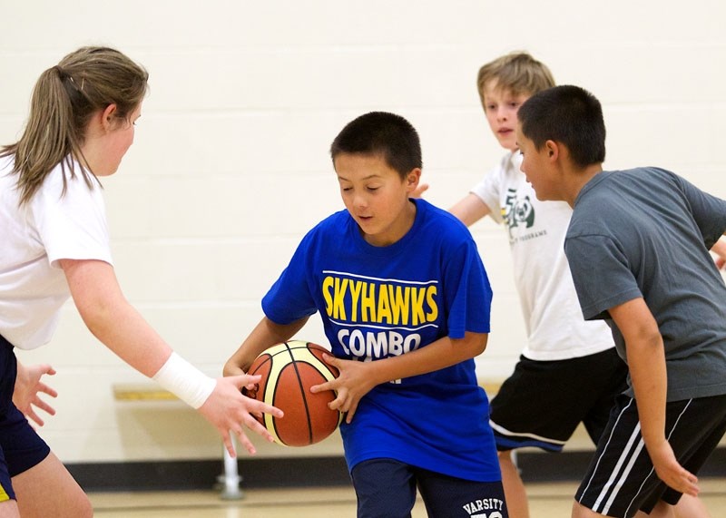 CAMPING OUT &#8211; Cameron Mah participates in a pass and cut drill at the fourth annual Skyhawks Basketball and Volleyball Combo Camp on Tuesday at St. Albert Catholic High 