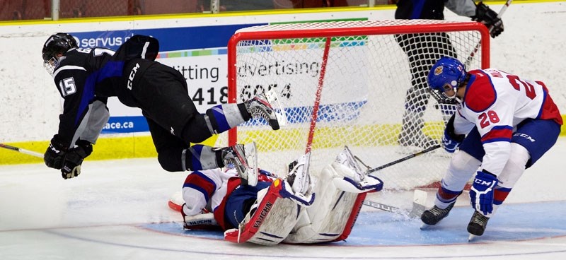 TRIPPED UP &#8211; Glenn Gawdin of the Swift Current Broncos takes a spill after netminder Tristan Jarry makes a save at the seventh annual Edmonton Oil Kings&#8217;