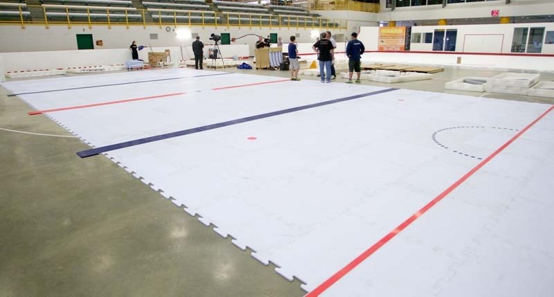 ALTERNATIVE ICE – Installers of two different types of synthetic ice ready the surfaces for the first skate at Servus Credit Union Place.