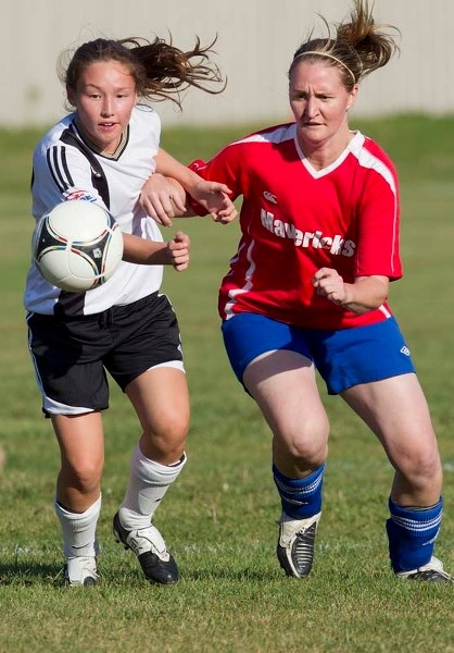 PLAYOFF BATTLE &#8211; Devan Tamura (left) of SA Force and Lindsey Hornung of Mavericks 09 grapple for the ball in the St. Albert Women&#8217;s Soccer League division one