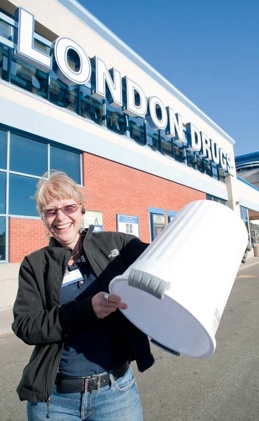 NO TRASH HERE — Stock manager Linda Helberg demonstrates the amount of trash the St. Albert London Drugs now typically tosses every week: nothing. The store got rid of its