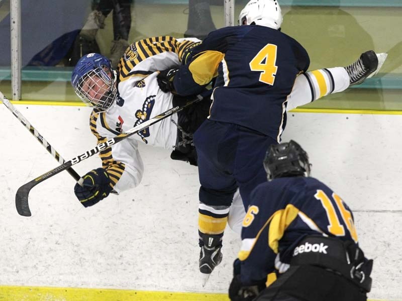 SPLAT &#8211; Kole Bryks of the St. Albert Raiders nails a Leduc player into the boards in the Alberta Midget AAA Hockey League home opener Saturday at Akinsdale Arena. The
