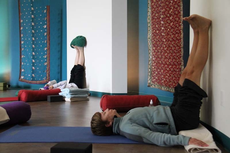 GOOD FOR YOU – Jeanette Espie relaxes in a yoga posture with her legs up the wall during a restorative yoga class at the Wellness Within spa and yoga centre at the Enjoy