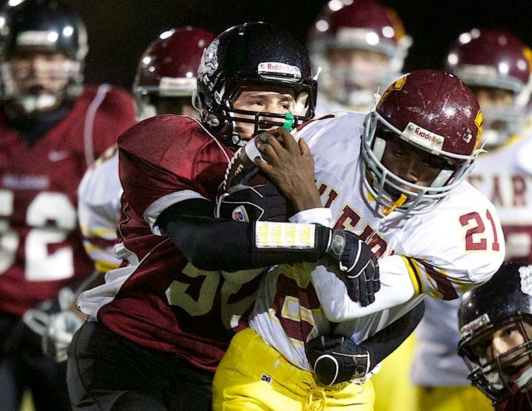 TIGHT GRIP &#8211; Mike Clapp of the Bellerose Bulldogs squeezes the O&#8217;Leary ball carrier in Tuesday&#8217;s metro Edmonton junior pool B game at Riel Recreation Park.