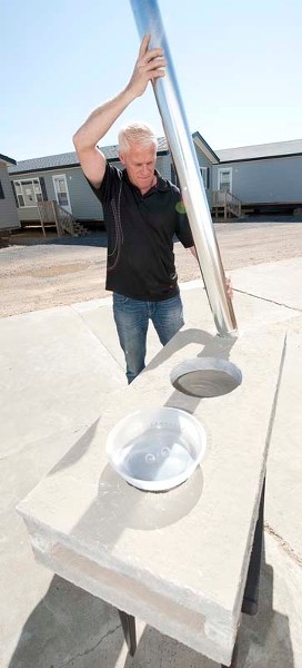 FUTURE BUILDER — Simon Boersma of Morinville&#8217;s Pleasant Homes assembles a mock-up of the concrete stoves he helps villagers in poverty-stricken nations build through