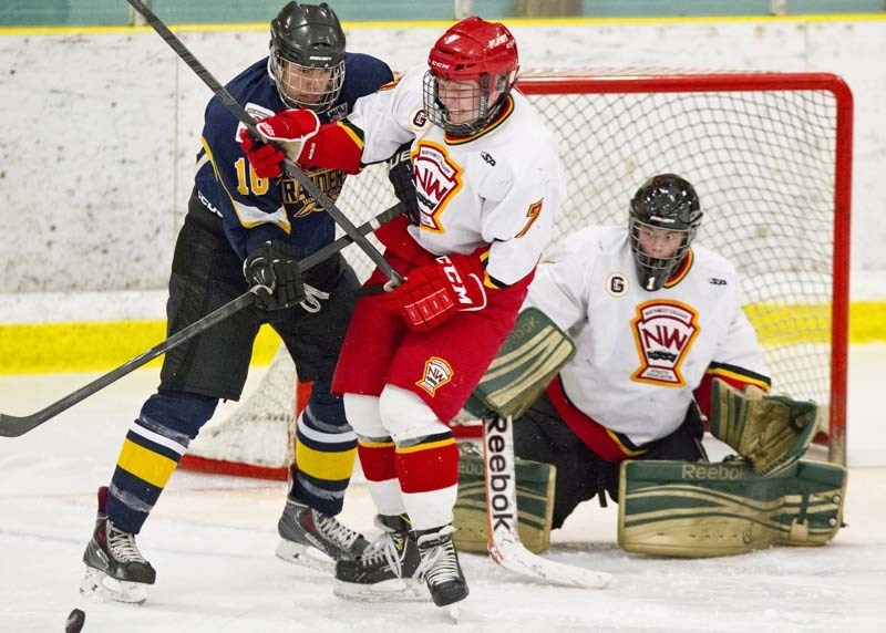 STICK WORK &#8211; Luc Smith of the St. Albert Raiders checks Erik Kardash of the Calgary Flames in front of netminder Austin Hannaford in Sunday&#8217;s midget AAA game at