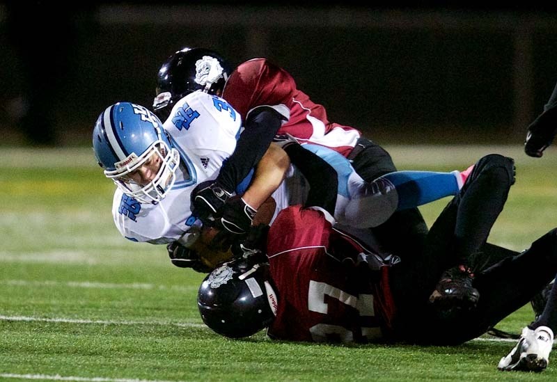 SMOTHERED &#8211; Brandon Smith of the Paul Kane Blues is wrapped up by Evan Nelson (bottom) and Autuen Metallic of the Bellerose Bulldogs in Tuesday&#8217;s metro Edmonton