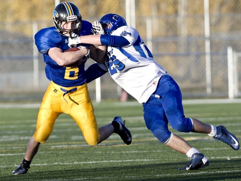 HANDCUFFED &#8211; Dan Tilley of the St. Albert High Skyhawks is tracked down by Brendan Briesen of the Ardrossan Bisons in the metro Edmonton league&#8217;s Miles conference 