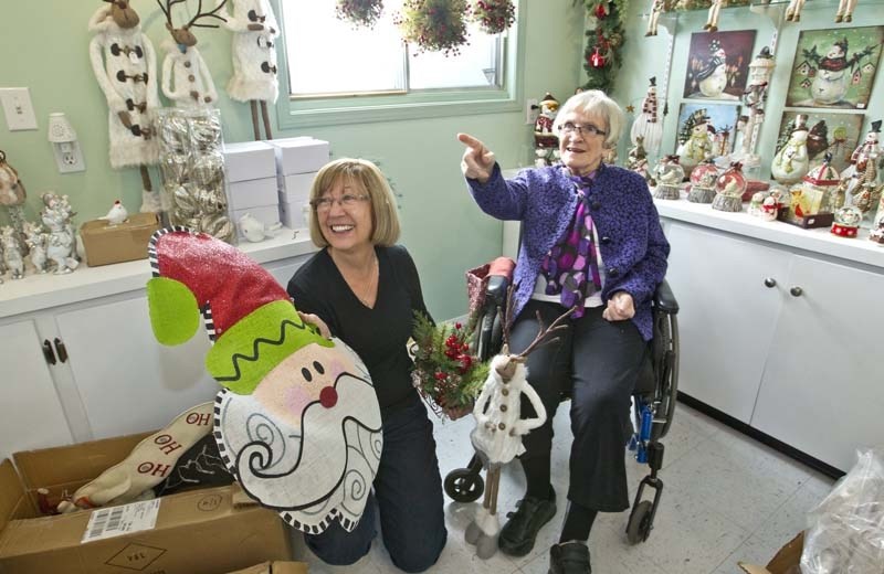 GETTING READY – Volunteers Diane Goodall (left) and Moira Mason get ready for the annual Christmas in October sale at the St. Albert Botanic Park gift shop.