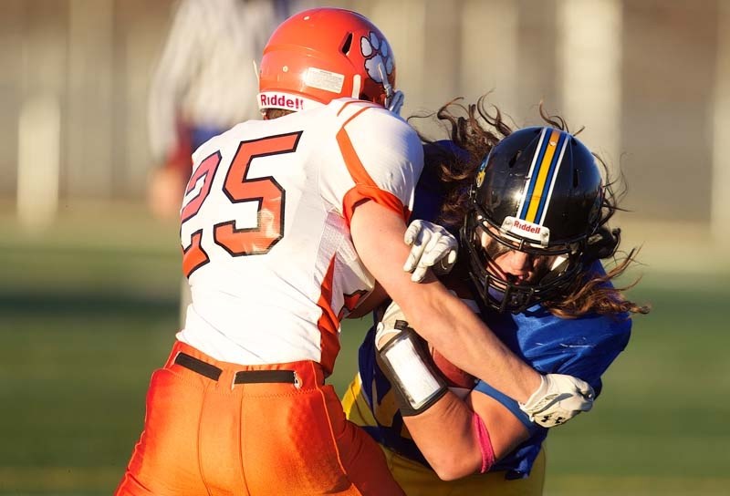 PUSHING FORWARD &#8211; Logan Tait-Vanderheide of the St. Albert High Skyhawks carries the rock against the McNally Tigers in Miles conference football action Thursday at
