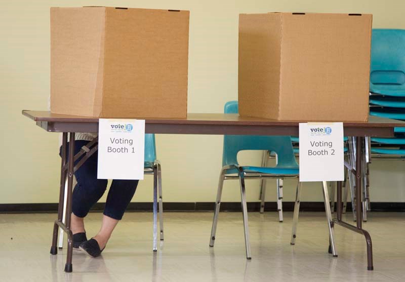 DEMOCRACY IN ACTION – A St. Albert voter makes her choices Monday afternoon at Braeside Presbyterian Church.