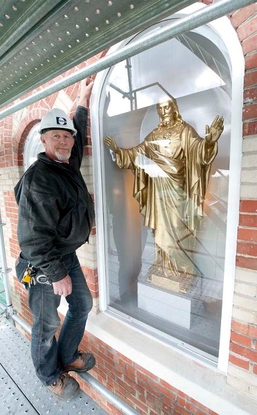 NEW HOUSE OF THE LORD — Don Ferguson stands by new enclosure he built for the icon of Jesus Christ at the St. Jean Baptiste Church in Morinville.