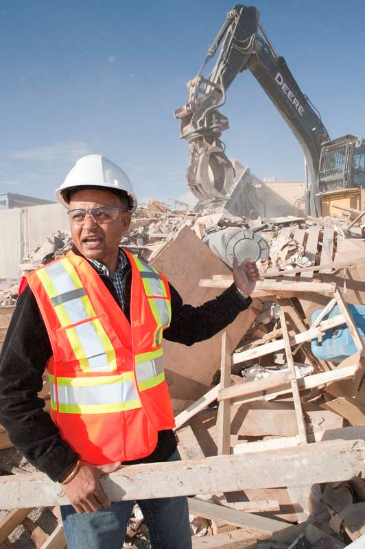 SORTING THROUGH THE MESS — Site supervisor Shailesh Modak shouts over the noise of the crane behind him as he explains the kinds of material they receive at Edmonton&#8217;s