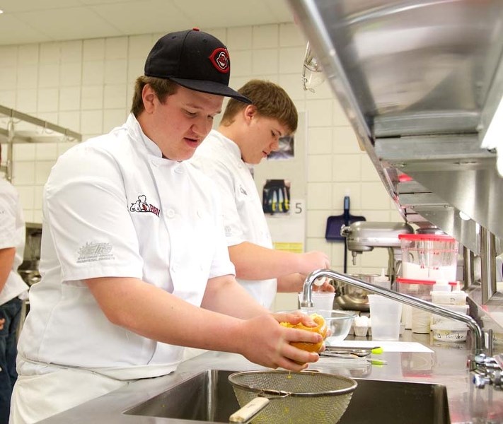 DONE LIKE DINNER – Calvin Lewis prepares a pumpkin dish on Thursday at Bellerose in preparation for the upcoming family dinner on Oct. 30.