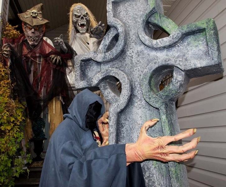 SCARY PLACE – Halloween decor enthusiast Ingrid Carli stands in full costume in front of her home in Erin Ridge on Monday. For the past 10 years the Carlis&#8217; have made