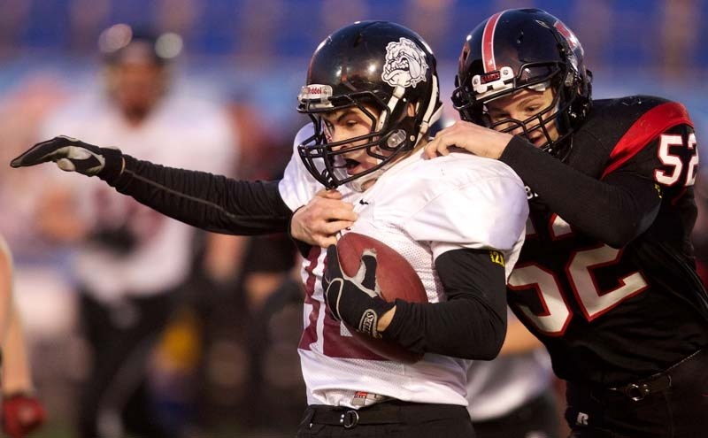 CLUTCH AND GRAB &#8211; Luke Mascotto-Wright of the Bellerose Bulldogs is tracked down from behind by Mitch Brinston of the Salisbury Sabres in Friday&#8217;s Carr conference 