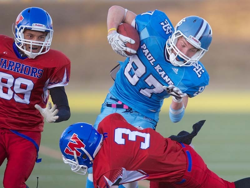 FORCES COLLIDE &#8211; Tyler Turner of the Paul Kane Blues braces for impact on the tackle attempt by Jake Dancey of the W.P. Wagner Warriors in Friday&#8217;s Miles