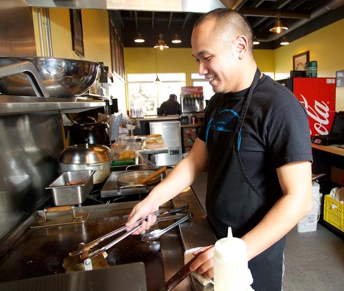 BEEF BEAUTY – Owner Tu Le prepares burgers for a customer at Jack&#8217;s Burger on Wednesday.