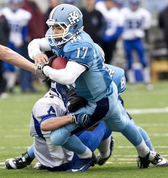 PLAYER OF THE GAME &#8211; Paul Kane Blues quarterback Cory Knott is dragged down by the Ardrossan Bisons in the Miles conference final Saturday in metro Edmonton high school 