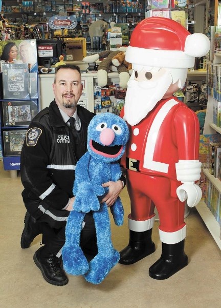 TOYS FOR TICKETS – Municipal enforcement officer Garnet Melnyk shows off some toys that could be used to pay off city parking tickets between Nov. 15 and Nov. 30.