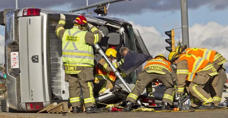 CLOSE CALL – Firefighters cut a man out of his vehicle Oct. 31 after a pickup truck and sedan collided at the intersection of Muir Drive and McKenney Avenue. St. Albert RCMP