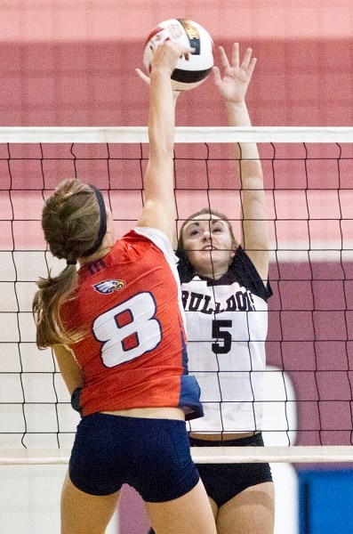 PLAYOFF SHOWDOWN &#8211; Mikaela Tziklas of the Bellerose Bulldogs throws up a block in Thursday&#8217;s semifinal against the Strathcona Christian Academy Eagles. The