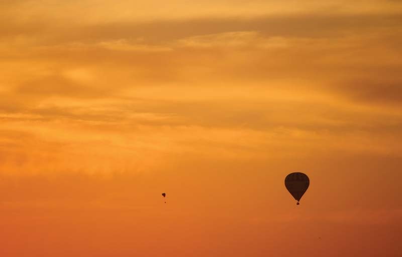 AIR PLAY – This photo by a Grade 6 student shows a hang glider playfully circling a hot air balloon.