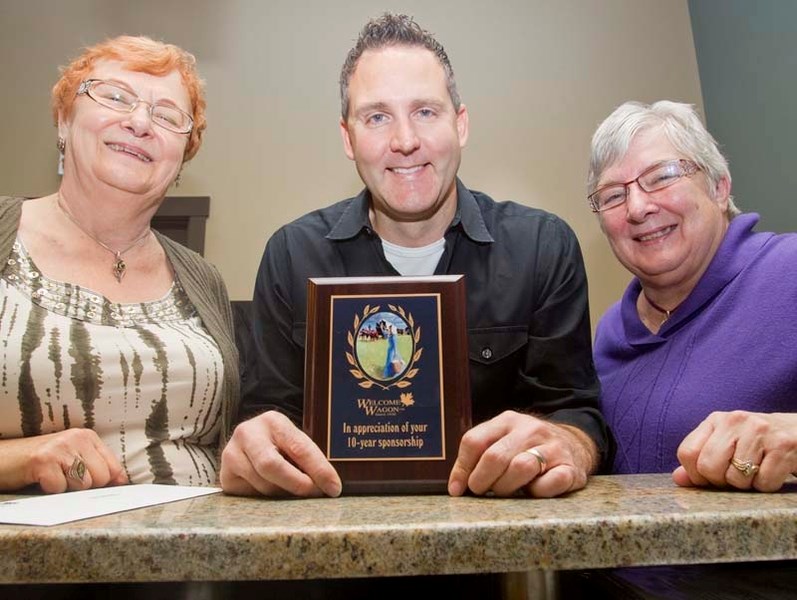 WELCOME WAGON – St. Albert Welcome Wagon honoured dentist Kurt Popowich with a 10-year plaque recently. Popowich advertises with the Welcome Wagon to get his name out to new