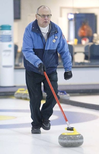 STICK CURLING &#8211; Garry Sherman lines up a shot at the 2012 two-person stick curling provincials at the St. Albert Curling Club. The Didsbury duo of Sherman and Carson