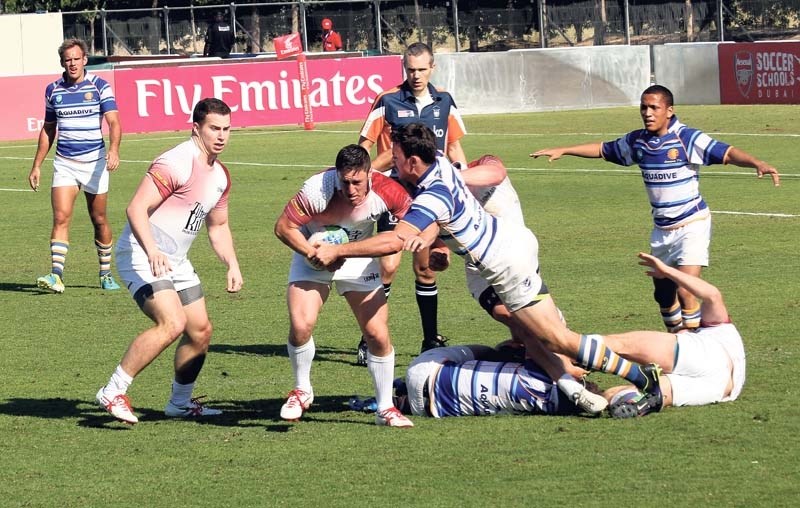RUGBY 7&#8217;S &#8211; Jake Robinson of the St. Albert Rugby Football Club attempts to break away from a tackle with the Lionheart 7&#8217;s at the recent Emirates Dubai
