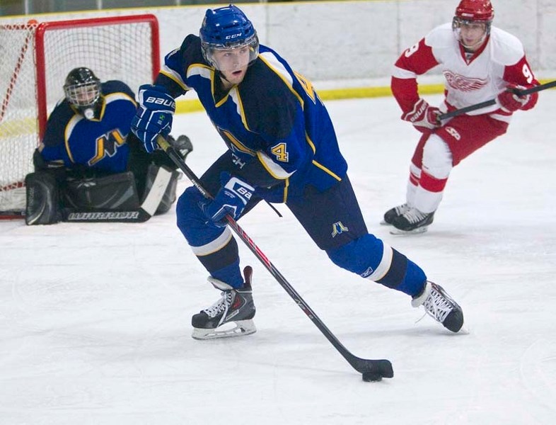 MERCHANTS WIN AGAIN &#8211; Jed Groenenboom of the St. Albert Merchants controls the puck in front of netminder Justin Pawlenchuk in Sunday&#8217;s 11-3 rout of the North