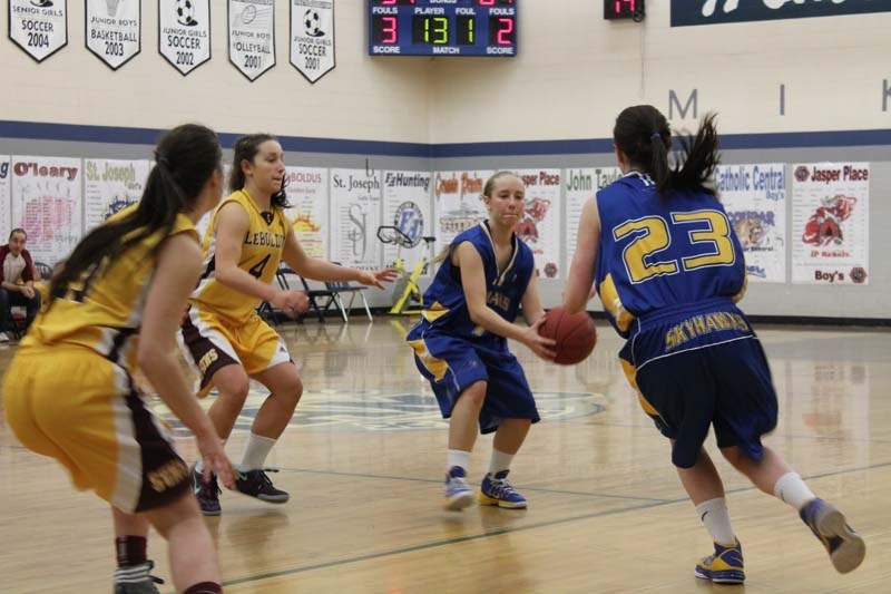 PASS PLAY &#8211; Isabelle Durocher of the St. Albert Skyhawks hands the ball off to Brielle Wise against the Dr. Martin LeBoldus Golden Suns of Regina in Saturday&#8217;s