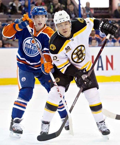 FAN FAVOURITE &#8211; Jarome Iginla of the Boston Bruins and Ryan Nugent-Hopkins of the Edmonton Oilers position themselves for the puck Thursday at Rexall Place. Iginla