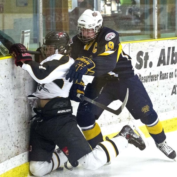 BOARDING &#8211; St. Albert Flyers captain Ryan Cox rubs out a Lloydminster Rage player along the boards in last weekend&#8217;s midget 15 game at Akinsdale Arena. In the 1-1 