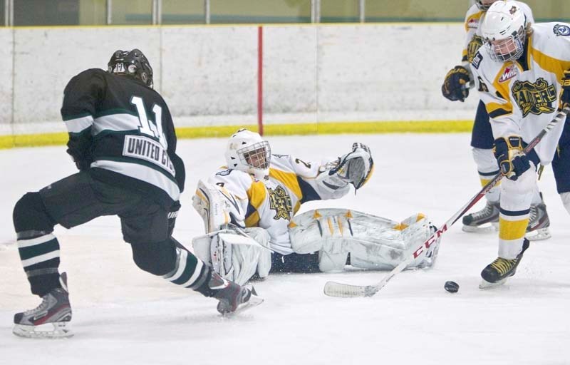 GRACE UNDER PRESSURE &#8211; St. Albert Sabres netminder Chris Curr makes a sprawling save against Grahame Blanchette of the Sherwood Park Flyers