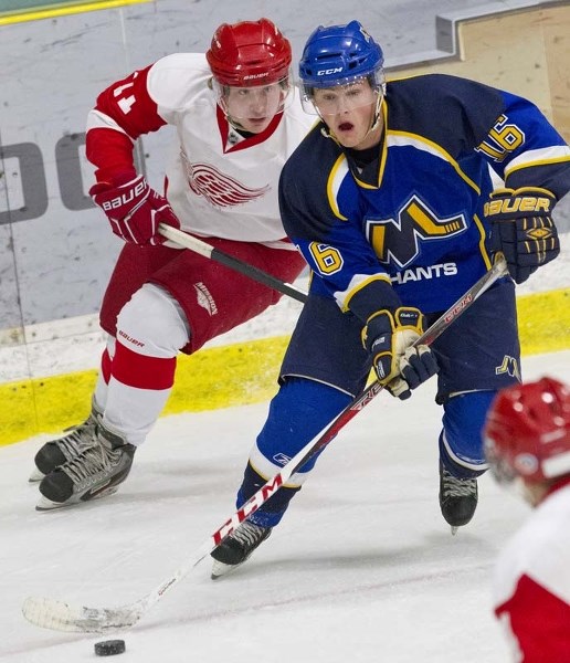 PUCK MOVER &#8211; Jeff Harrison of the St. Albert Merchants looks to make a pass while pressured by Tom Brennan of the North Edmonton Red Wings in Friday&#8217;s 4-1 win at