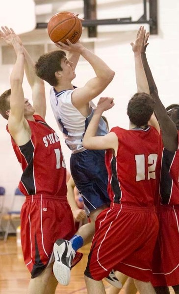BLUES RISE UP &#8211; Theo Block of the Paul Kane Blues aims to sink a shot while surrounded by (L-R) Mike Woywitka