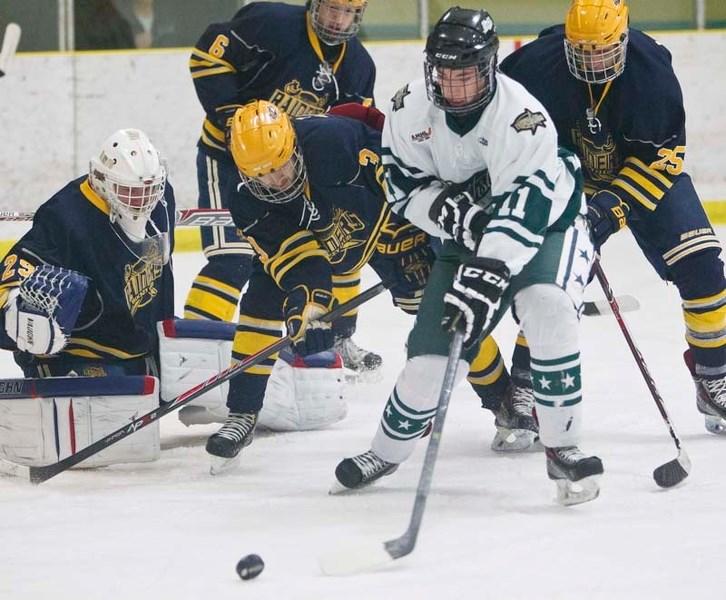 DEFENDING THE NET &#8211; Yuri Chernichko of the Calgary Northstars plays the puck in front of netminder Pat Dea