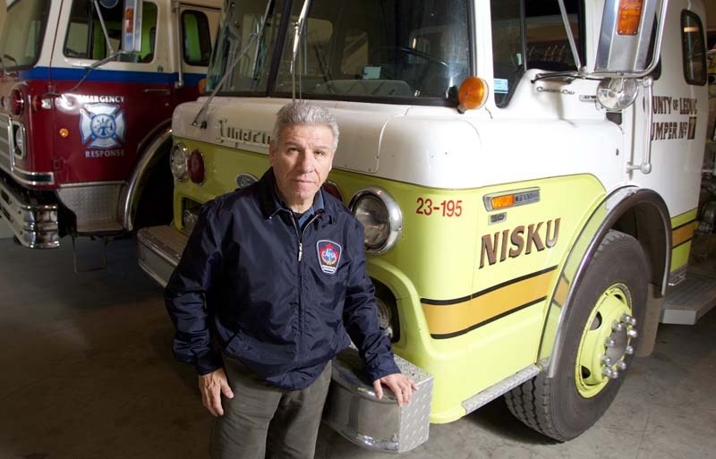 FIREFIGHTER&#8217;S CALLING – Victor Fernandez stands with a newly donated firetruck from Leduc County Fire Services. Fernandez refurbishes firetrucks that are at the end of