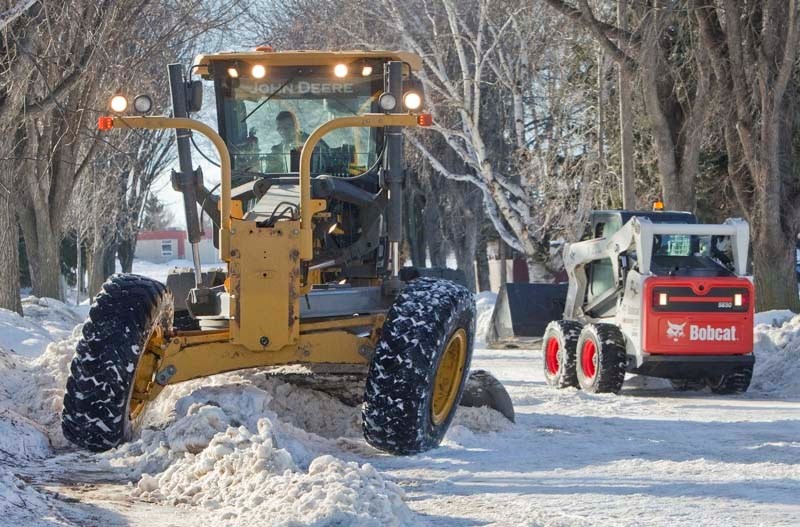STAND BACK – City crews have begun to clear snow pack from residental streets across St. Albert as temperatures in the area continue to rise. Removing deep snow