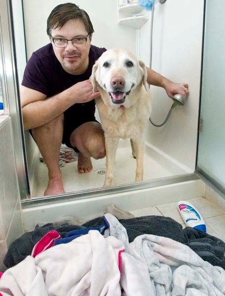 THAT&#8217;S BETTER – St. Albert resident Tim (last name withheld by request) gives his dog Misty a hot shower after she fell through the ice while on a walk on the Sturgeon