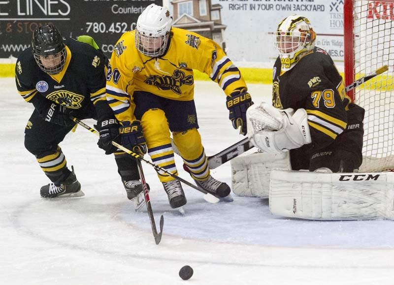 PUCK CHASER &#8211; Liam Peyton of the St. Albert Gregg Distributors Sabres skates across the crease for the puck against the Burnaby Winter Club Bruins at the John Reid