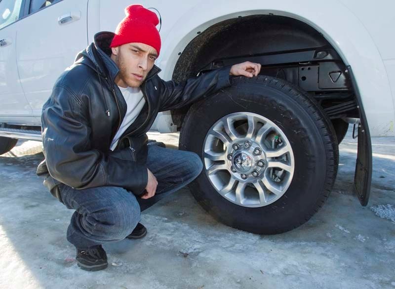WHEELS TAKEN – St. Albert Dodge lot technician Eric Grouse shows a set of rims like the ones that were recently stolen from three pickup trucks parked in the