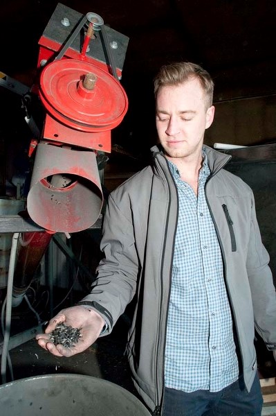 CHAR OF THE FUTURE – Construction Waste Demolition co-owner Andy Chapman collects some of the biochar produced by the biochar machine his company is testing near Millet.