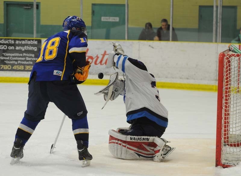 SCORING CHANCE &#8211; Morinville Jets&#8217; netminder Mike Brown stops a shot in front of Brent McGugan of the St. Albert Merchants in Friday&#8217;s junior B game at