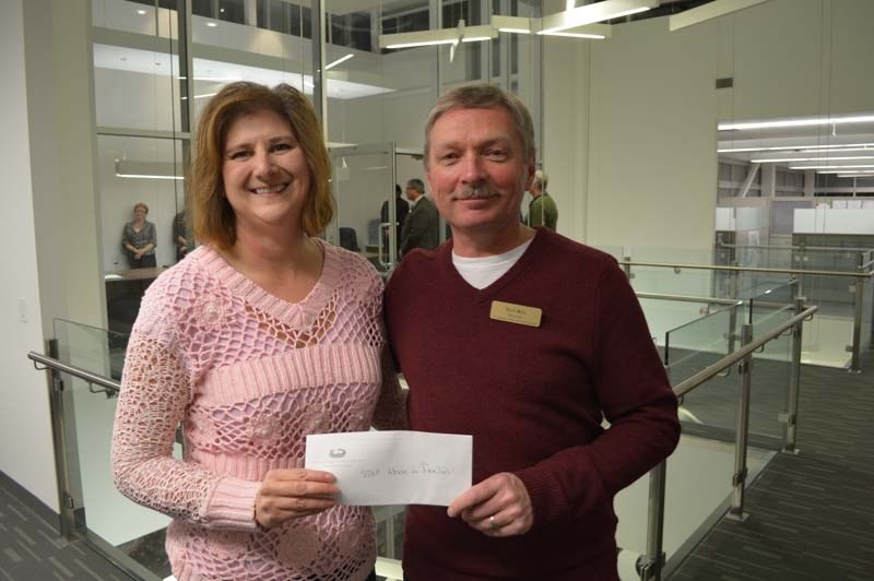 MUCH APPRECIATED – Doreen Slessor accepts a donaiton from representative Dan Roy at The Gazette office last December.